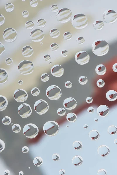 Close-up view of transparent droplets on blurred abstract background — Stock Photo