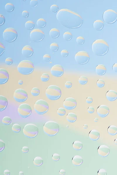 Close-up view of transparent rain drops on light abstract background — Stock Photo