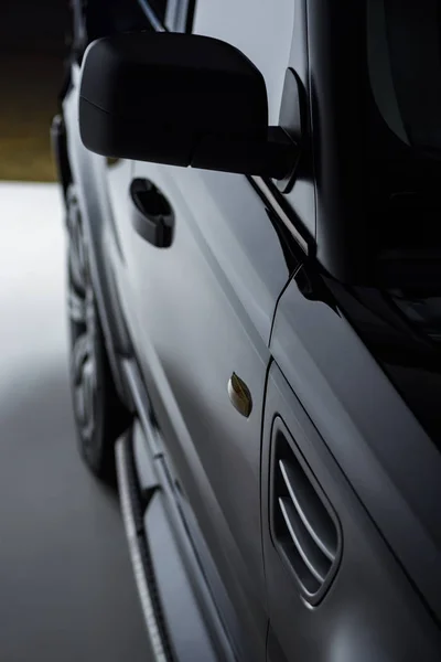 Close up view luxury shining black automobile on dark background — Stock Photo