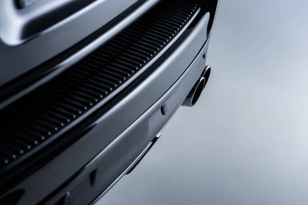 Nahaufnahme schwarzer Luxuswagen vor grauem Hintergrund — Stockfoto