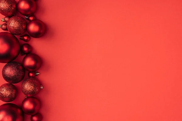 Top view of decorative red christmas balls isolated on red — Stock Photo