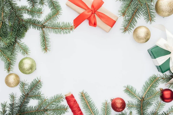 Flat lay with arranged pine tree branches, gifts and christmas toys isolated on white — Stock Photo