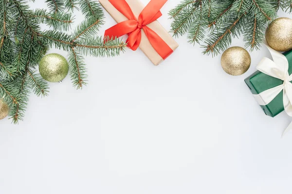 Flat lay with arranged pine tree branches, gifts and christmas toys isolated on white — Stock Photo