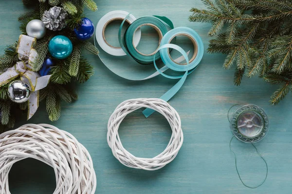 Top view of arranged decorations for handmade christmas wreath on blue wooden tabletop — Stock Photo