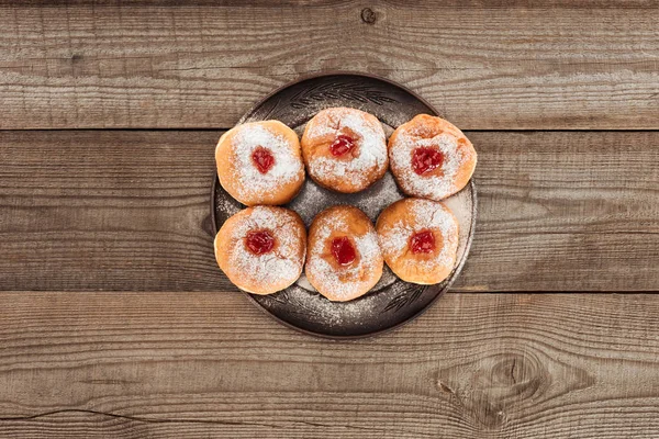 Top view of sweet donuts on wooden tabletop, hannukah celebration concept — Stock Photo