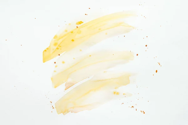 Abstract orange watercolor strokes and blots on white paper background — Stock Photo