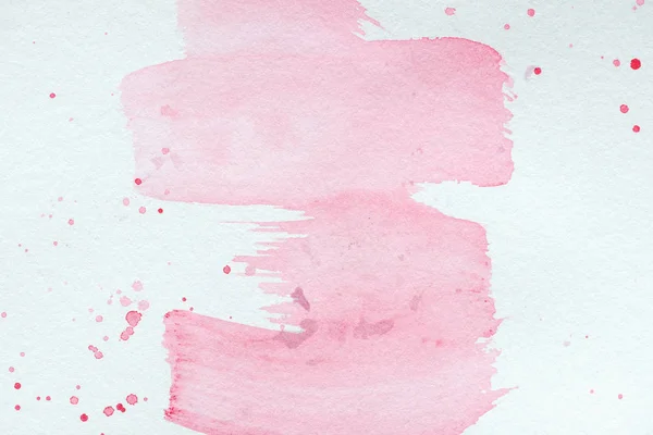 Abstrakte, kreative Textur mit rosa Aquarellstrichen und Spritzern — Stockfoto