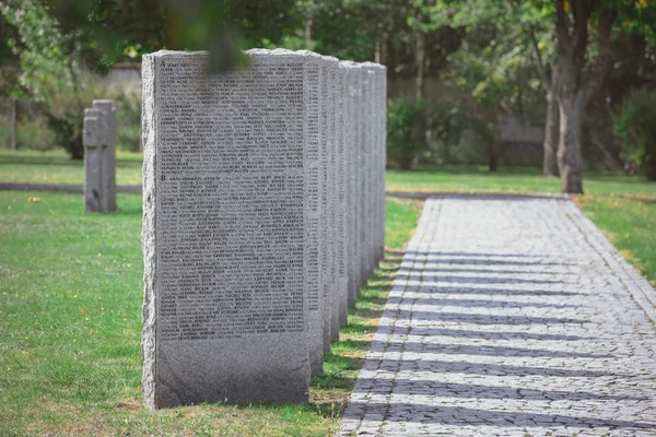 Identical tombs with lettering placed in row at graveyard — Stock Photo