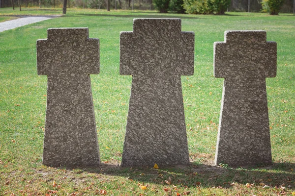 Close up image of memorial stone crosses placed in row at graveyard — Stock Photo