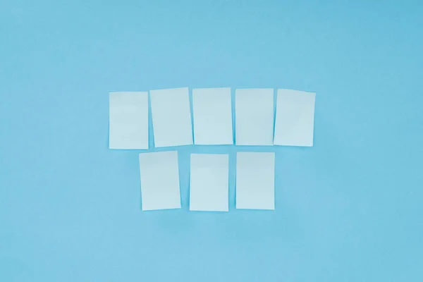 Eight blank sticky notes isolated on blue background — Stock Photo