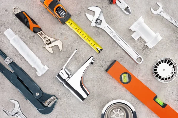Flat lay with various plumbing tools on concrete surface — Stock Photo
