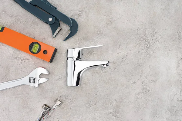 Top view of water mixer and tools on concrete surface — Stock Photo