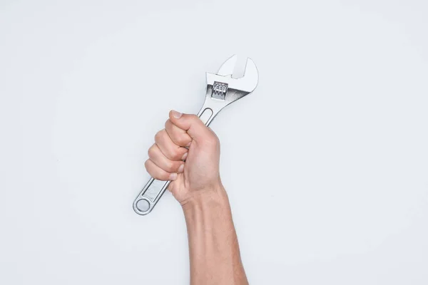 Cropped shot of man holding adjustable wrench isolated on white — Stock Photo