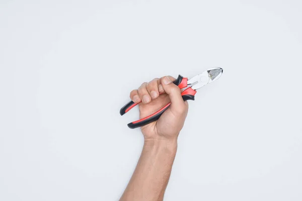 Cropped shot of man holding pliers isolated on white — Stock Photo