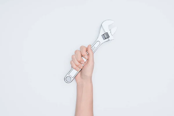 Cropped shot of woman holding adjustable pipe wrench isolated on white — Stock Photo