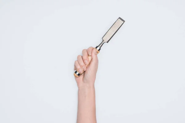 Cropped shot of woman holding chisel isolated on white — Stock Photo