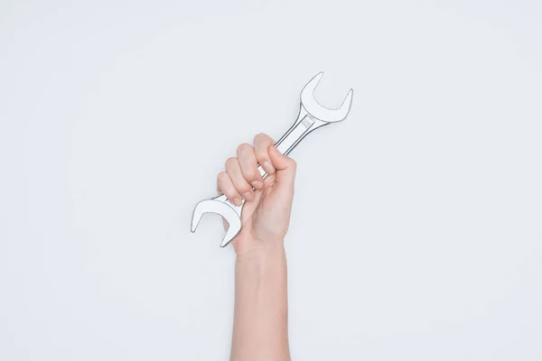 Cropped shot of woman holding wrench isolated on white — Stock Photo