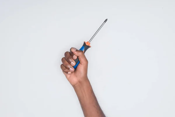 Cropped shot of african american man holding screwdriver isolated on white — Stock Photo