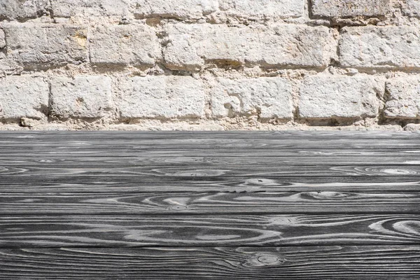 Template of grey wooden floor with white brick wall on background — Stock Photo