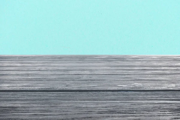 Template of grey wooden floor on turquoise background — Stock Photo