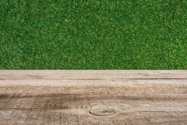 Template of brown wooden floor and green grass on background — Stock Photo