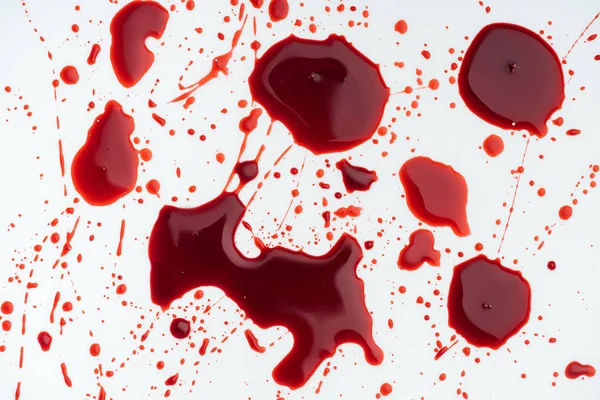 Close-up shot of messy blood droplets on white surface — Stock Photo