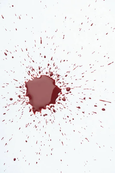 Top view of messy blood splash with small droplets on white surface — Stock Photo