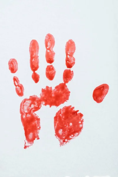 Top view of blood print made with hand on white surface — Stock Photo