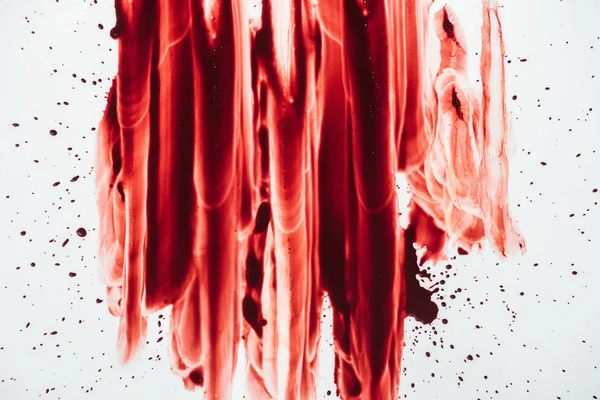 Top view of blood blots smeared down on white — Stock Photo