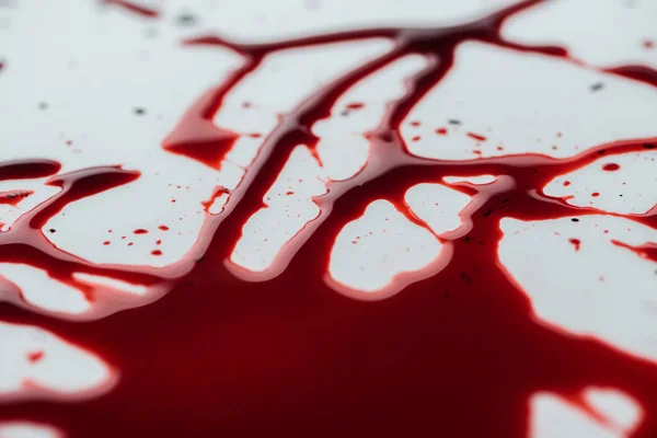 Close-up shot of messy blood droplets on white surface — Stock Photo