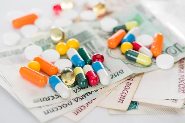 Selective focus of colorful various pills and russian cash money on surface — Stock Photo