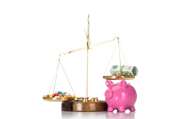 Close up view of pink piggy bank near scales with various colorful pills and russian cash money isolated on white — Stock Photo