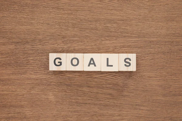 Top view of 'goals' word made of wooden blocks on wooden tabletop, goal setting concept — Stock Photo