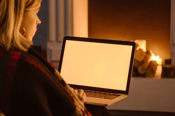 Cropped view of young woman using laptop with blank screen at home — Stock Photo