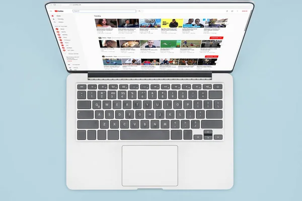 Top view of laptop with opened youtube website isolated on light blue — Stock Photo