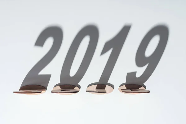 Top view of wooden numbers with 2019 shadow on white background — Stock Photo