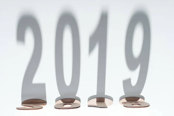 Top view of wooden numbers with 2019 shadow on white background — Stock Photo