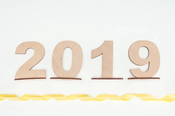 Top view of 2019 date made of wooden numbers with yellow ribbon isolated on white — Stock Photo