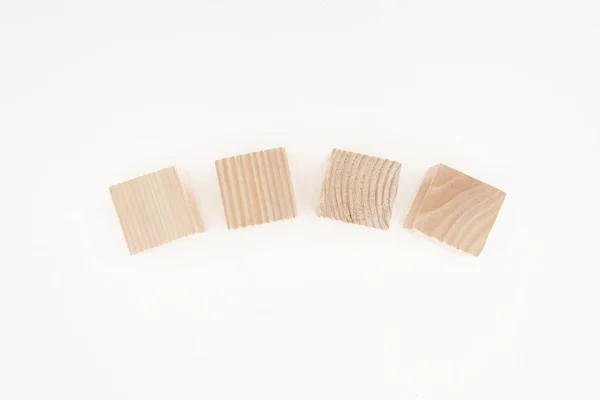 Vista superior de quatro blocos de madeira isolados em branco — Fotografia de Stock
