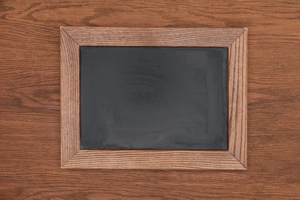 Top view of empty chalk board on wooden background — Stock Photo