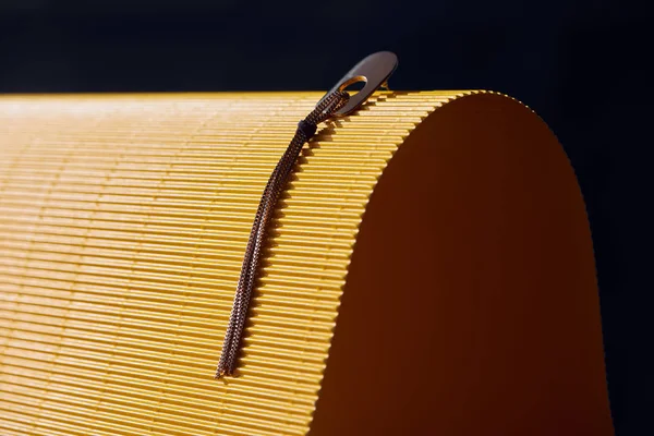 Beautiful earring on yellow and black striped surface — Stock Photo