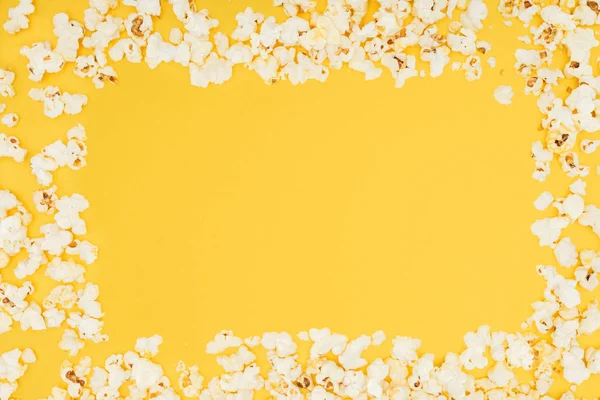 Frame made of fresh tasty popcorn isolated on yellow — Stock Photo