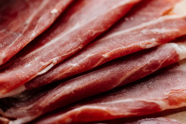 Close up view of delicious thin sliced prosciutto — Stock Photo