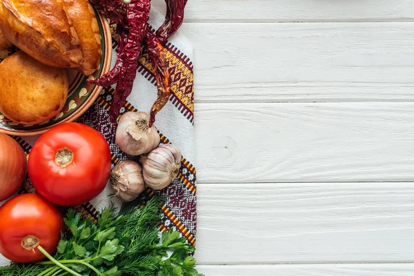 Top view of ingredients and mini pies on white wooden background with copy space — Stock Photo