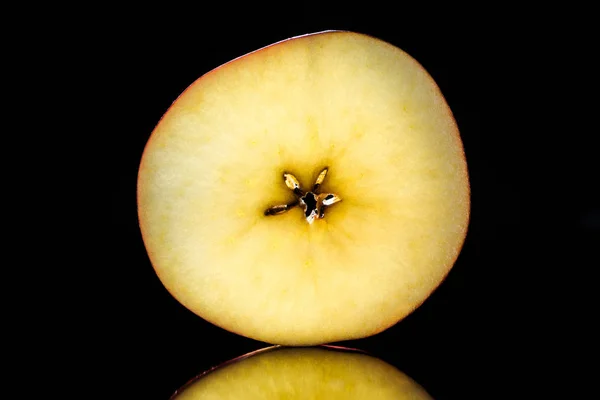 Half of ripe raw apple isolated on black — Stock Photo