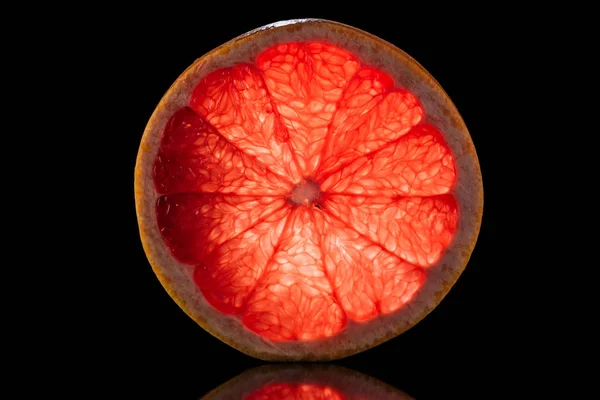 Slice of fresh ripe grapefruit isolated on black — Stock Photo