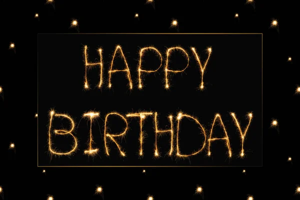 Close up view of happy birthday light lettering on black backdrop — Stock Photo