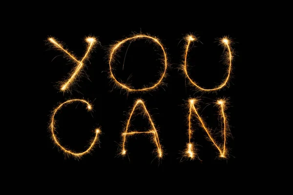 Close up view of you can light lettering on black backdrop — Stock Photo