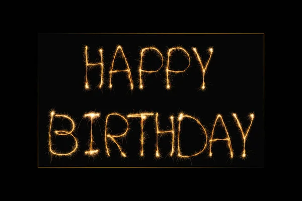 Close up view of happy birthday light lettering on black backdrop — Stock Photo