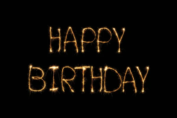 Vista de cerca de letras de luz de cumpleaños feliz en el fondo negro - foto de stock